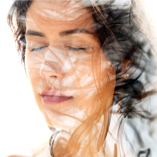 An image of smoke combined with a portrait of a young woman